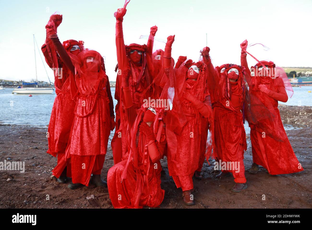 Teignmouth, South Devon, UK. 12th Dec, 2020. Members of Ocean Rebellion XR and the Red Rebels staged a peaceful protest in the seaside resort of Teignmouth. Protestors are calling for sludge dumping from Exmouth Docks to be stopped from dumping 10,000 tons of pollutants into an area of the sea where juvenile fish are developing.Locals feel angry that the sludge dumping took place during the lock down when protests could not legally take place. Credit: Natasha Quarmby/Alamy Live News Stock Photo