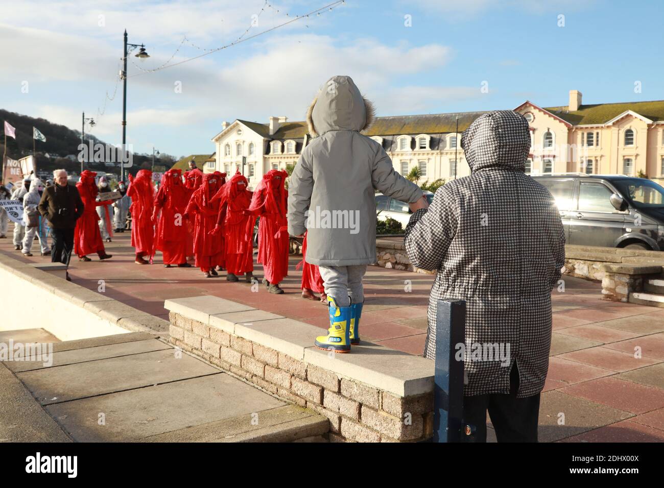 Teignmouth, South Devon, UK. 12th Dec, 2020. Members of Ocean Rebellion XR and the Red Rebels staged a peaceful protest in the seaside resort of Teignmouth. Protestors are calling for sludge dumping from Exmouth Docks to be stopped from dumping 10,000 tons of pollutants into an area of the sea where juvenile fish are developing.Locals feel angry that the sludge dumping took place during the lock down when protests could not legally take place. Credit: Natasha Quarmby/Alamy Live News Stock Photo