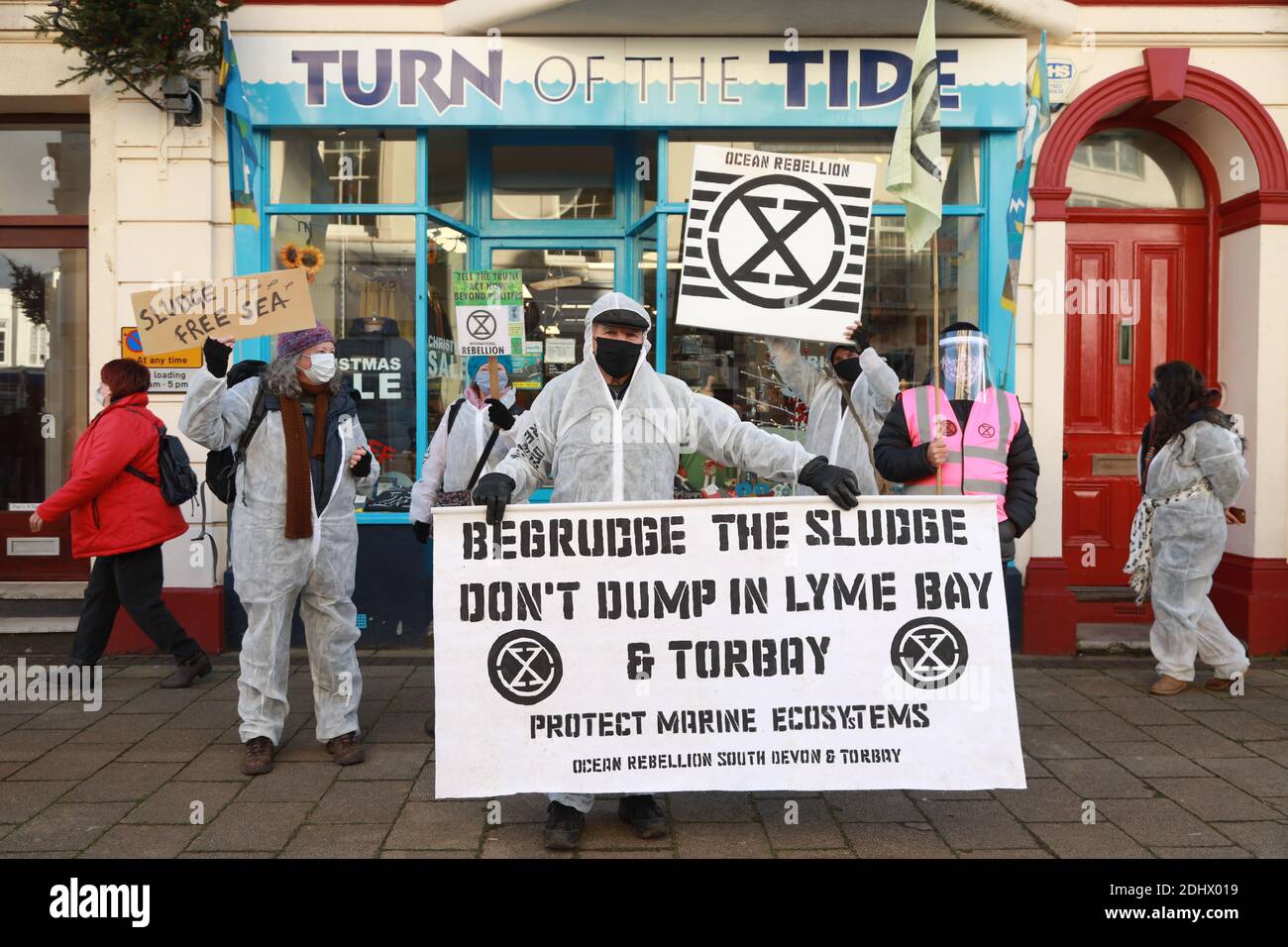 Teignmouth, South Devon, UK. 12th Dec, 2020. Members of Ocean Rebellion XR and the Red Rebels staged a peaceful protest in the seaside resort of Teignmouth. Protestors are calling for sludge dumping from Exmouth Docks to be stopped from dumping 10,000 tons of pollutants into an area of the sea where juvenile fish are developing.Locals feel angry that the sludge dumping took place during the lock down when protests could not legally take place. Credit: Natasha Quarmby/Alamy Live News Stock Photo