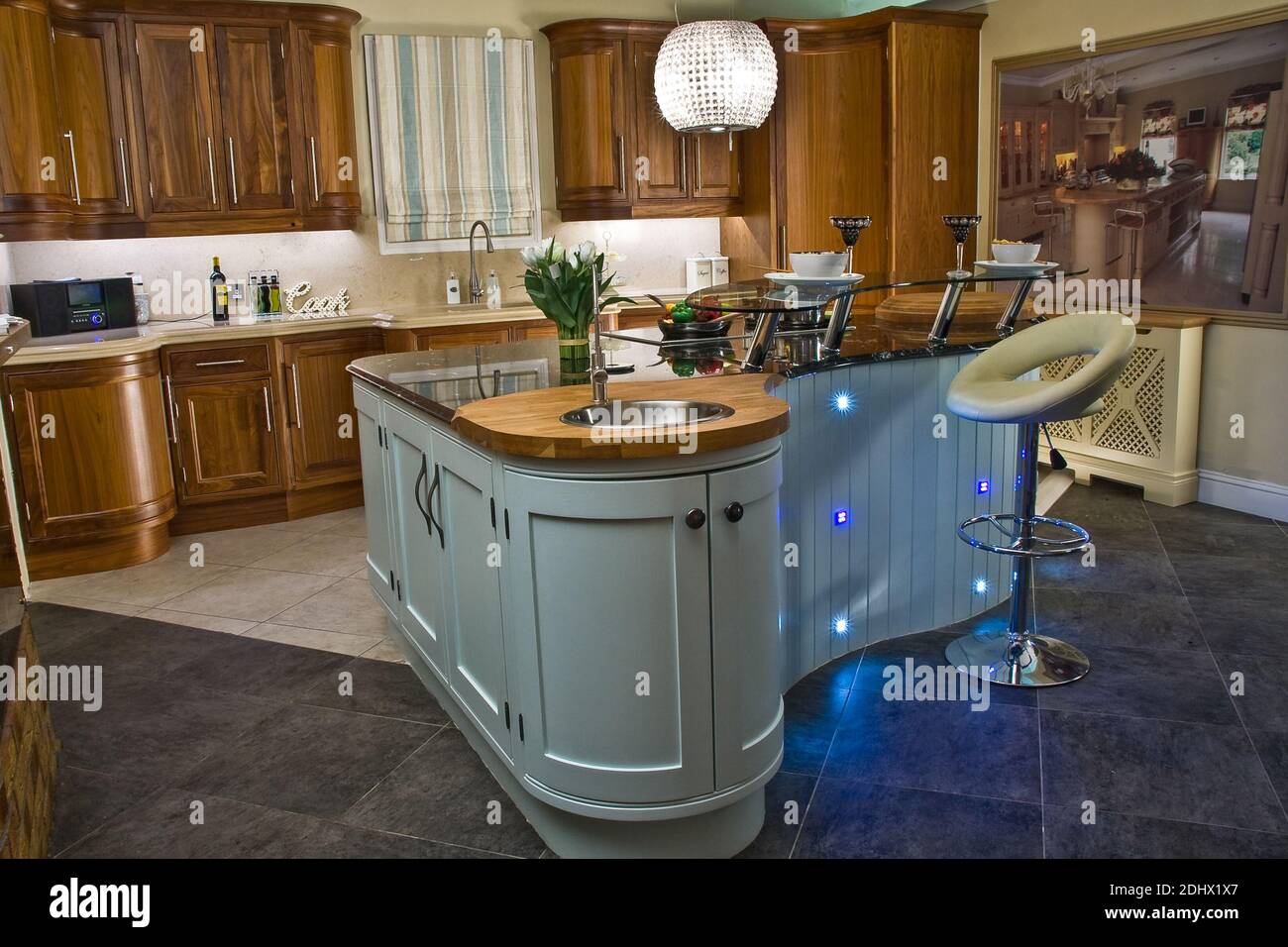 Contemporary kitchen with island in modern style with extractor fan