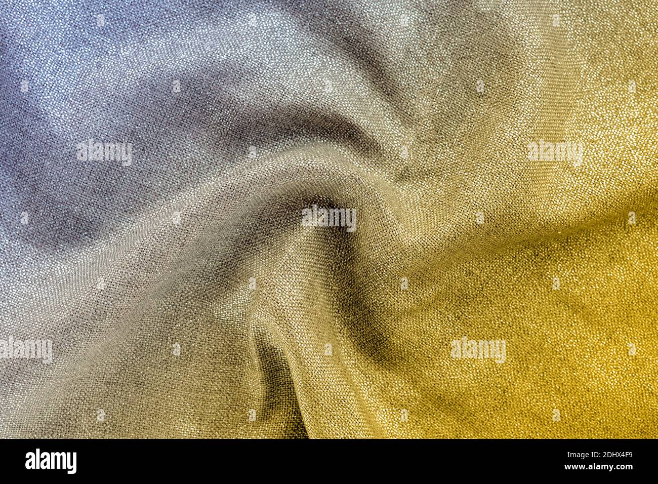 Shiny fabric with curl drape. Yellow and gray gradient, texture, background. Trendy colors 2021 Stock Photo
