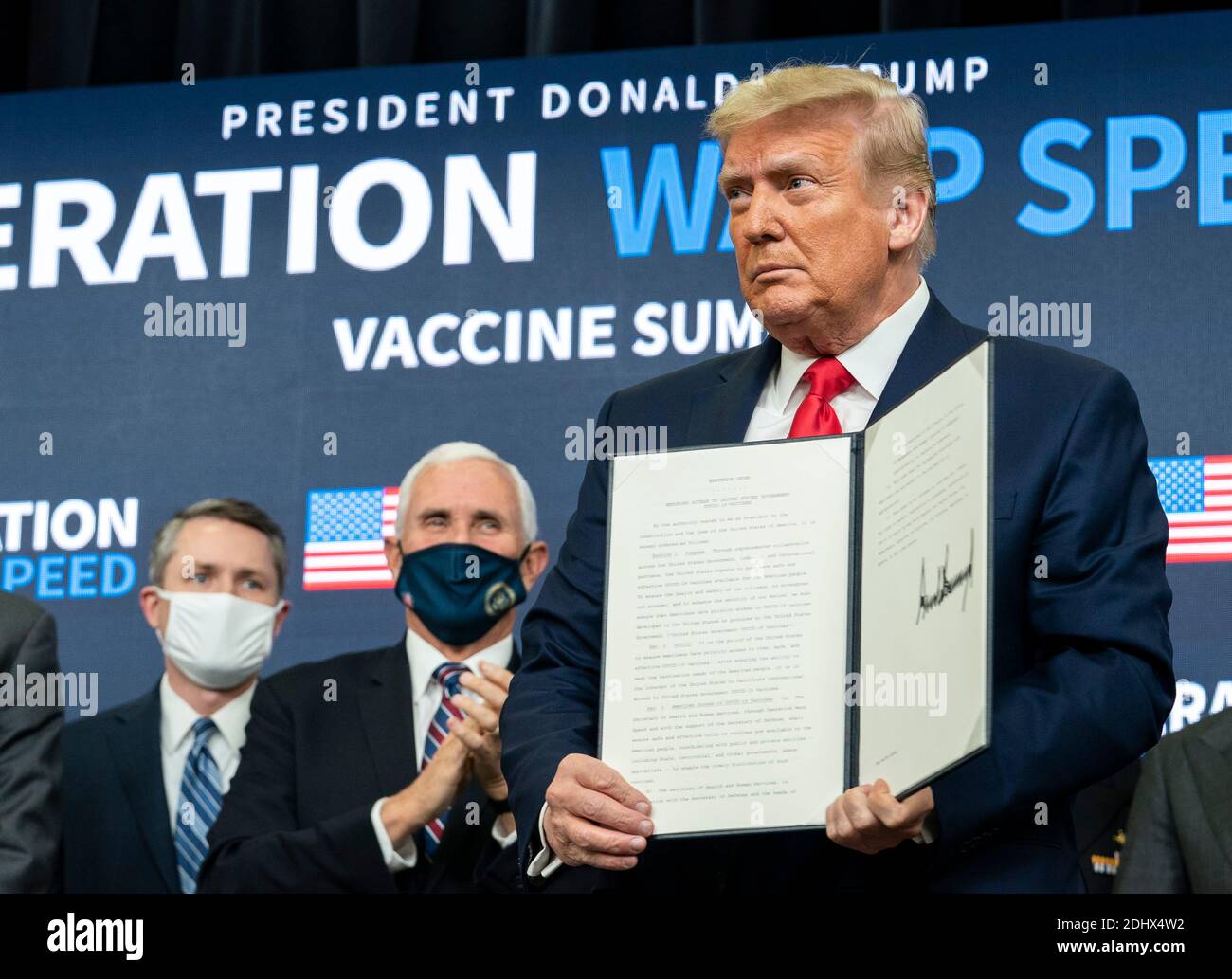 U.S President Donald Trump, joined by Vice President Mike Pence holds up a signed Executive Order on access to vaccines at the Operation Warp Speed Vaccine Summit in the South Court Auditorium at the Eisenhower Executive Office Building at the White House 8, 2020 in Washington, D.C. Stock Photo