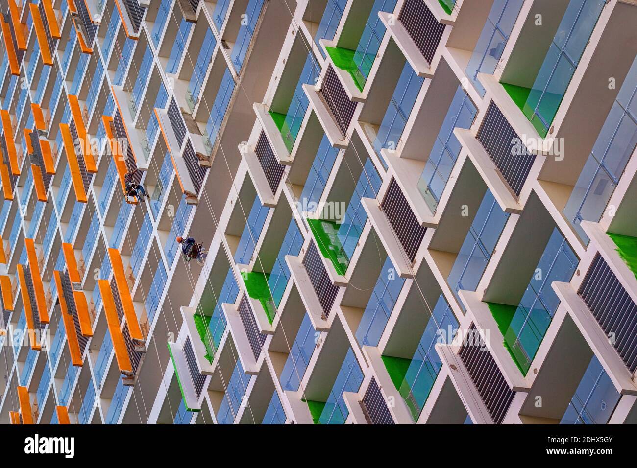 Two painters hanging doing work at a newly build Condo building. Stock Photo