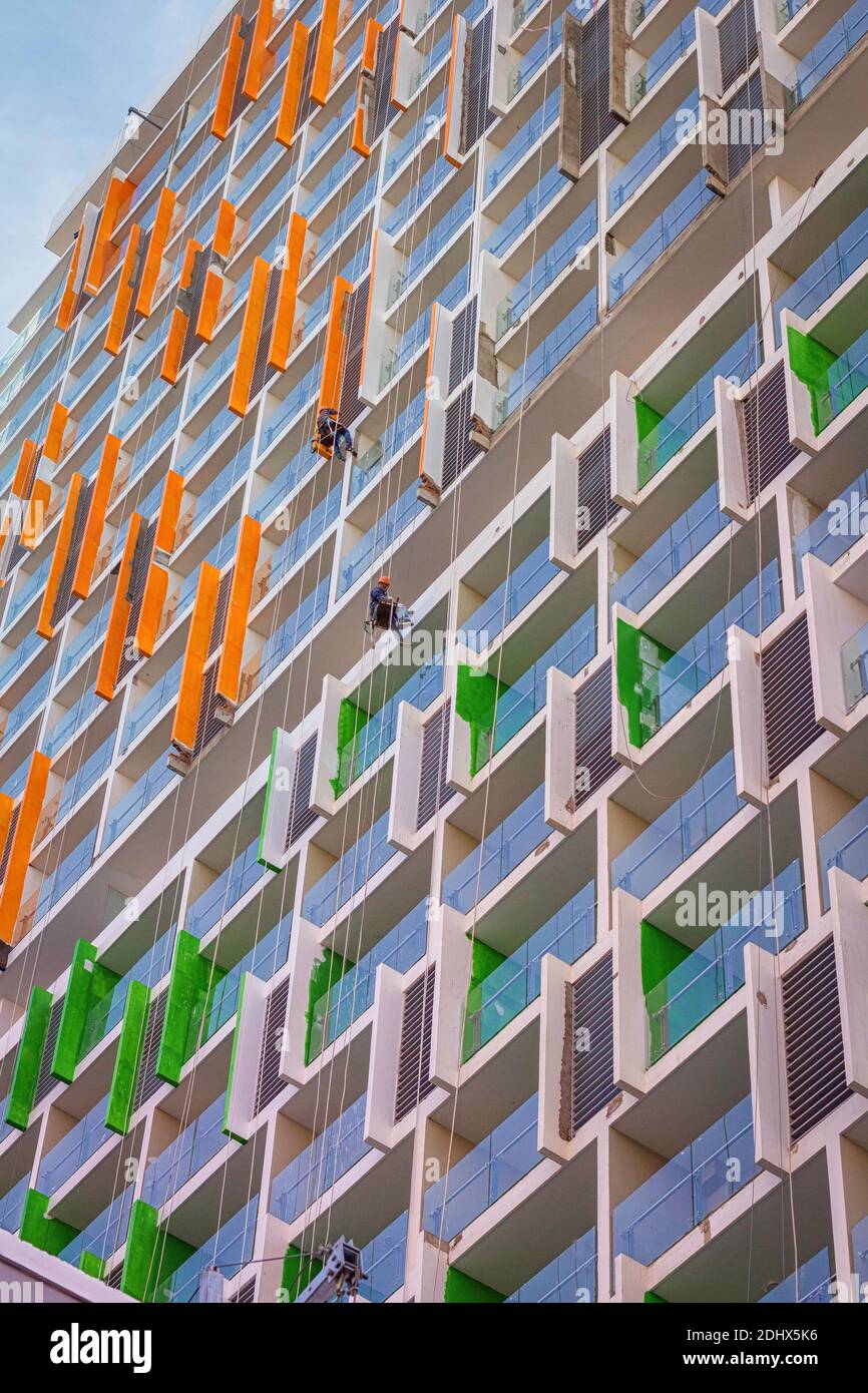 Two painters hanging doing work at a newly build Condo building. Stock Photo