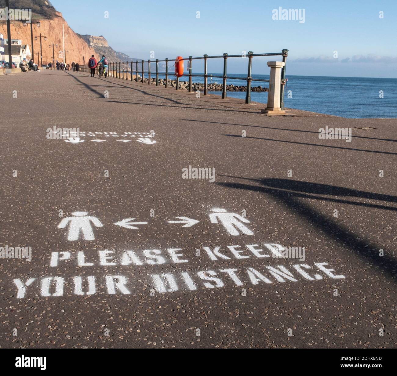 Keep your distance signs, social distancing, painted onto the Esplanade at Sidmouth, Devon, England, UK Stock Photo