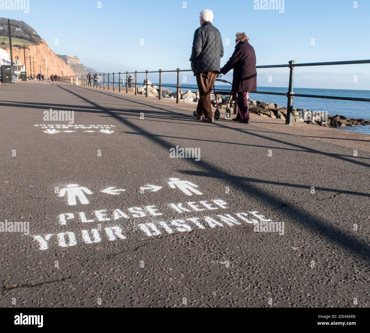 Keep your distance signs, social distancing, painted onto the Esplanade at Sidmouth, Devon, England, UK Stock Photo