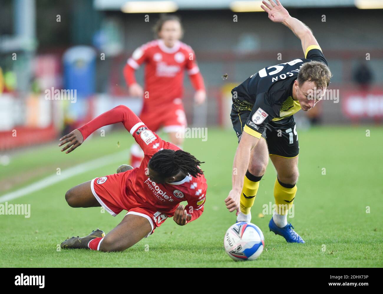 Crawley UK 12th December 2020 - David Sesay of Crawley is bundled over by Scott Wilson of Barrow during the Sky Bet EFL League Two match between Crawley Town and Barrow AFC  at the People's Pension Stadium - Editorial use only. No merchandising.  - for details contact Football Dataco  : Credit Simon Dack TPI / Alamy Live News Stock Photo