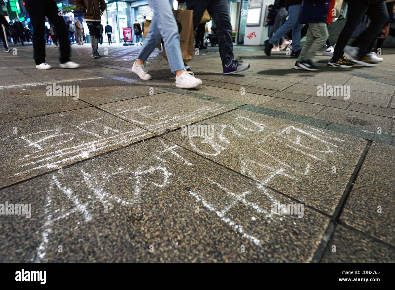 Request: 'Please keep your distance' on the floor in the pedestrian shopping zone in Dortmund, Germany, December 11th, 2020 Stock Photo