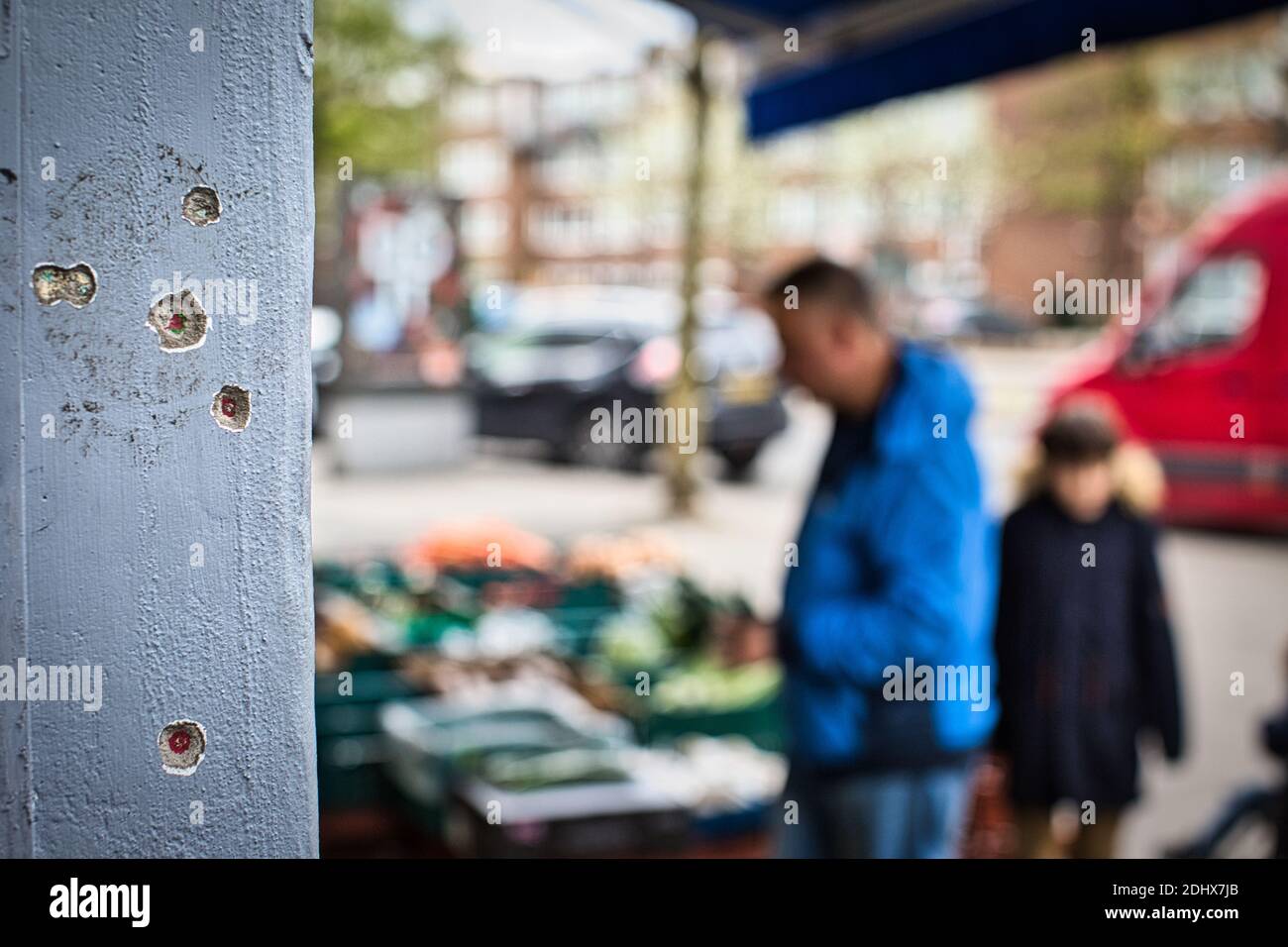 bullet holes outside wall after shooting in gang-related crime Stock Photo
