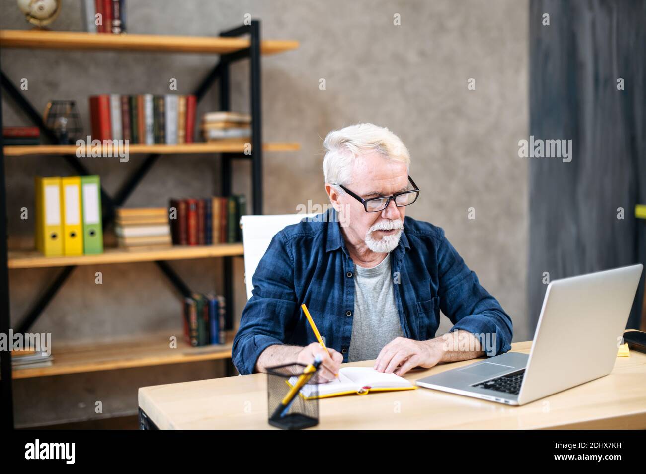 Older man using laptop for studying, working Stock Photo