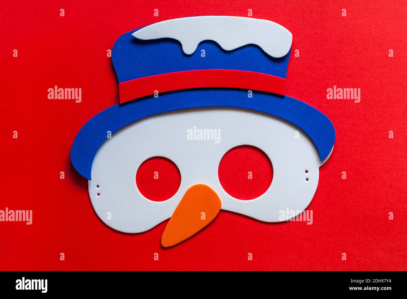 Materials to make snowman festive mask from Wilko Make your own Festive Masks set on red background Stock Photo