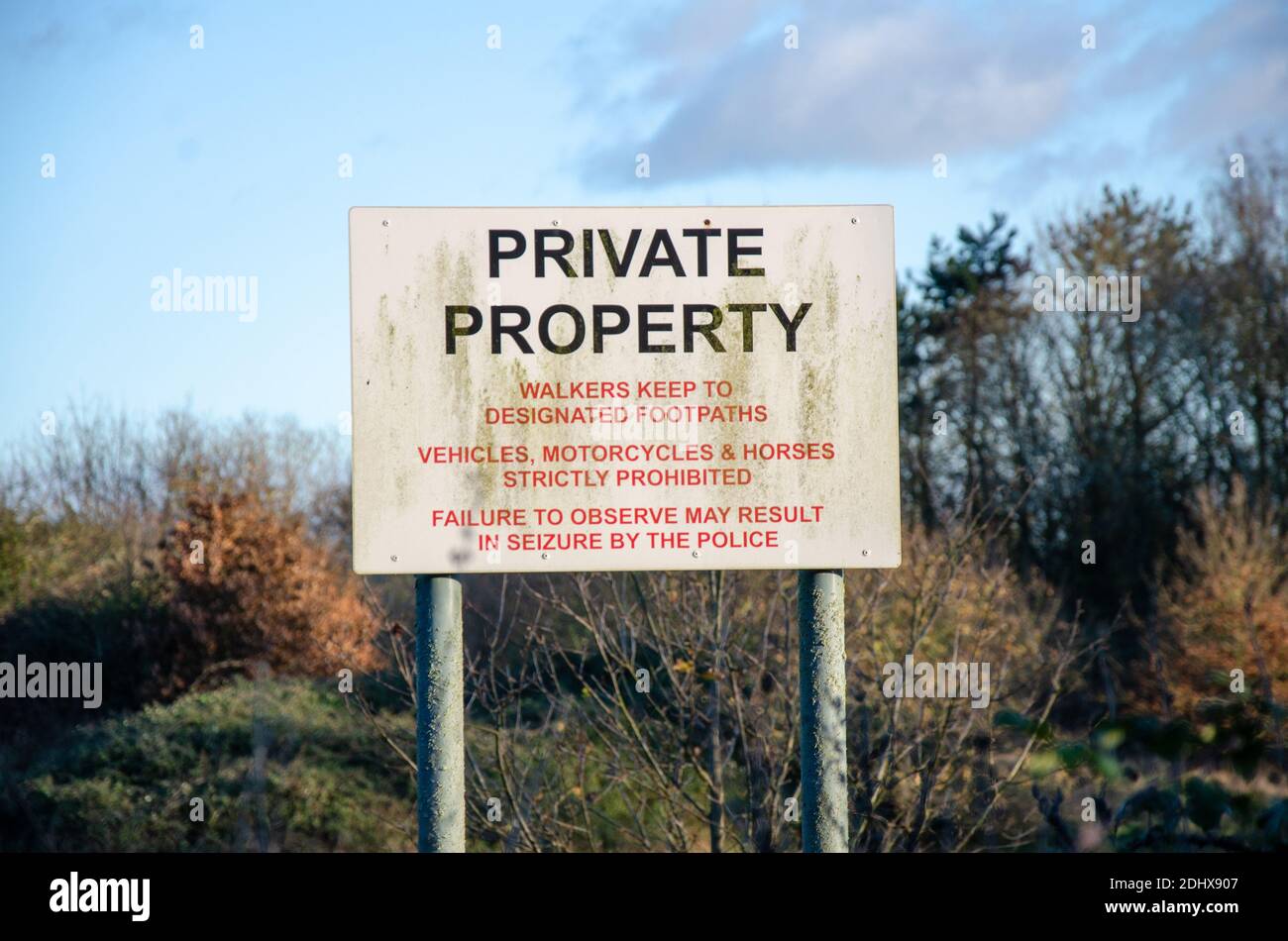 A sign in a field indicates that the field is private property and walkers must keep to paths, Stock Photo
