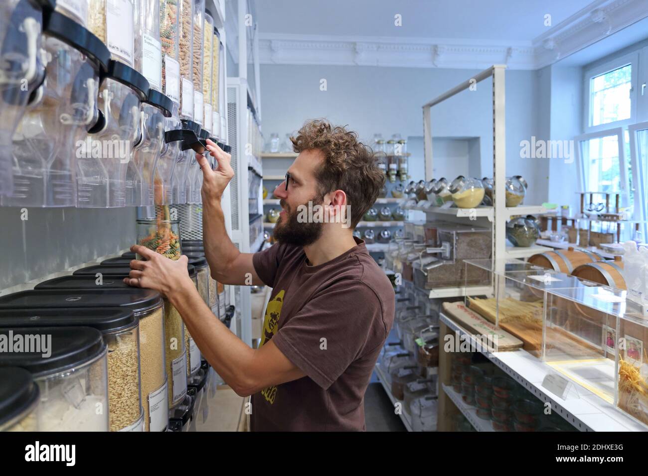 Germany / Berlin / Customers bring their own containers and fill them with anything from Pasta il to washing up liquid, at Original Unverpackt. Stock Photo