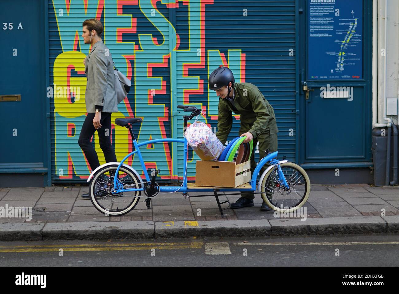 Cycle courier is delivering with cargo bike , London ,UK Stock Photo