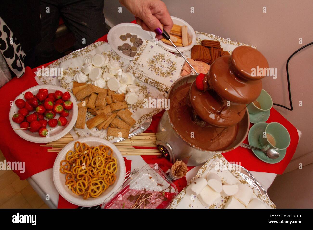 Strawberry in a chocolate fountain at a Suffolk village Christmas fair