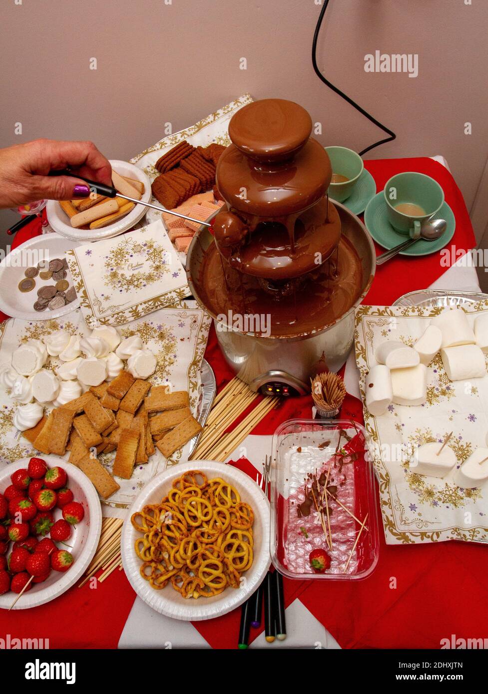 Strawberry in a chocolate fountain at a Suffolk village Christmas fair