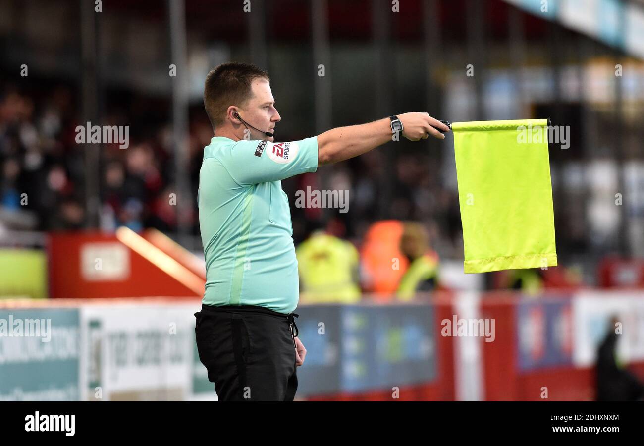 Crawley UK 12th December 2020 - Linesman or referees assistant raises his yellow flag for offside during the Sky Bet EFL League Two match between Crawley Town and Barrow AFC  at the People's Pension Stadium - Editorial use only. No merchandising.  - for details contact Football Dataco  : Credit Simon Dack TPI / Alamy Live News Stock Photo