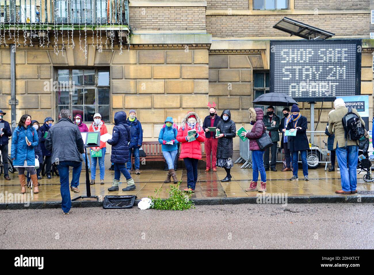 cambridge uk, 12122020,Adults gather to sing christmas carols outside