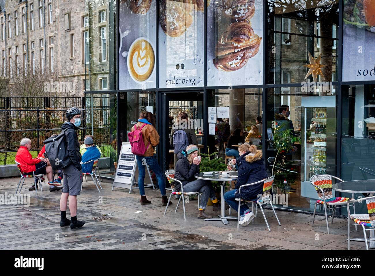 Customers sitting at tables outside Soderberg The Meadows on Middle Meadow Walk in Edinburgh, Scotland, UK. Stock Photo