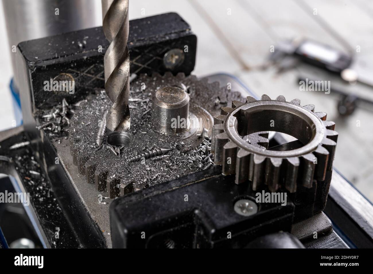 Drilling a hole in metal. Metal works performed with a drill. Dark