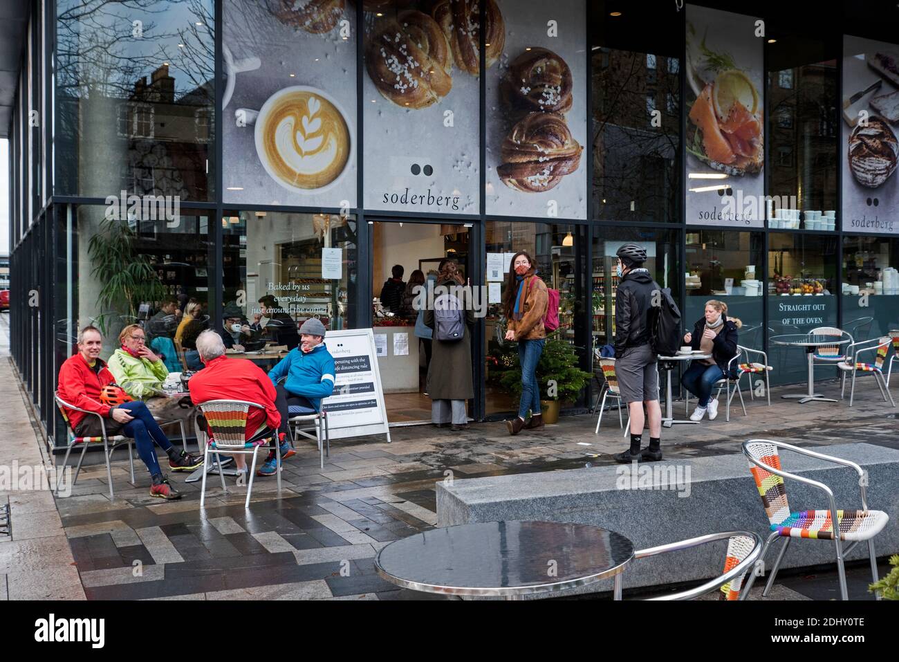 Customers sitting at tables outside Soderberg The Meadows on Middle Meadow Walk in Edinburgh, Scotland, UK. Stock Photo