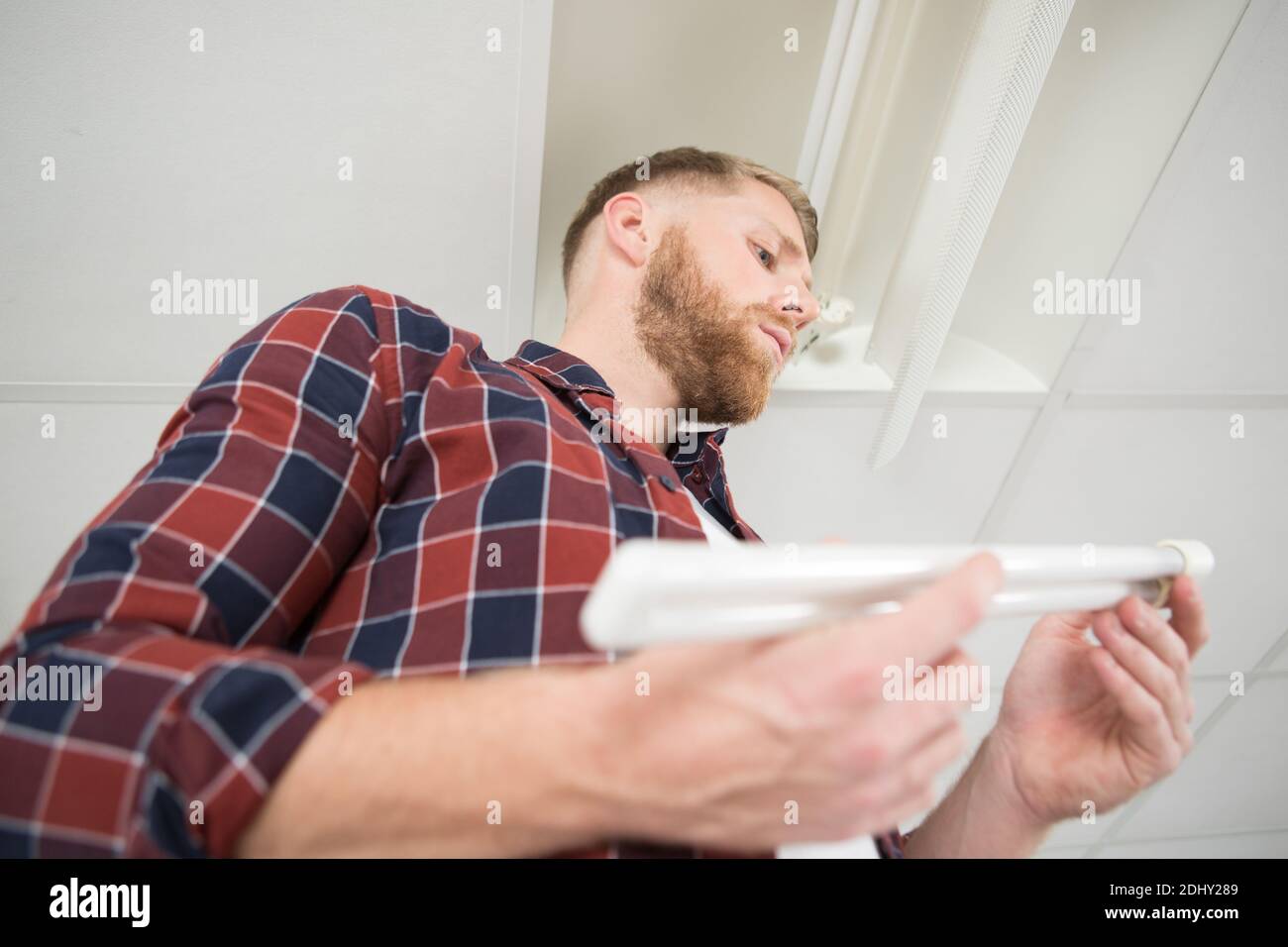 electrician installing ceiling fluorescent lamp Stock Photo - Alamy