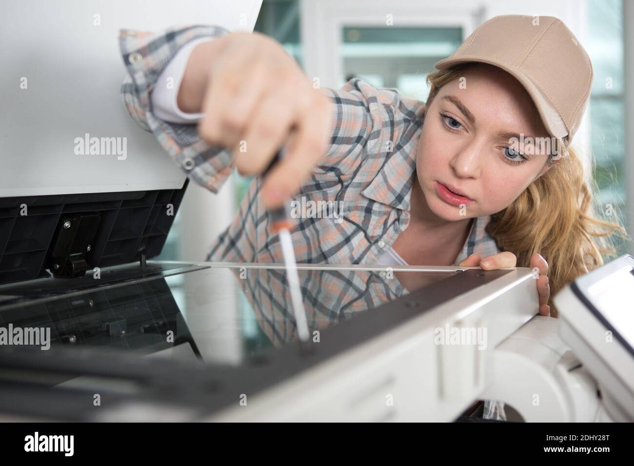 female technician fixing printer Stock Photo