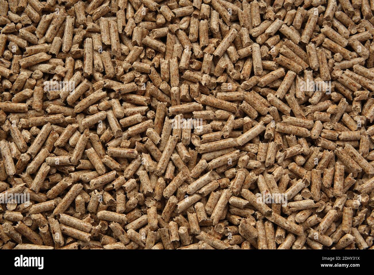 Wood pellets texture. Pellets made from compressed wood and used as natural cat litter. Eco-friendly and biodegradable material. Flat lay image. Stock Photo