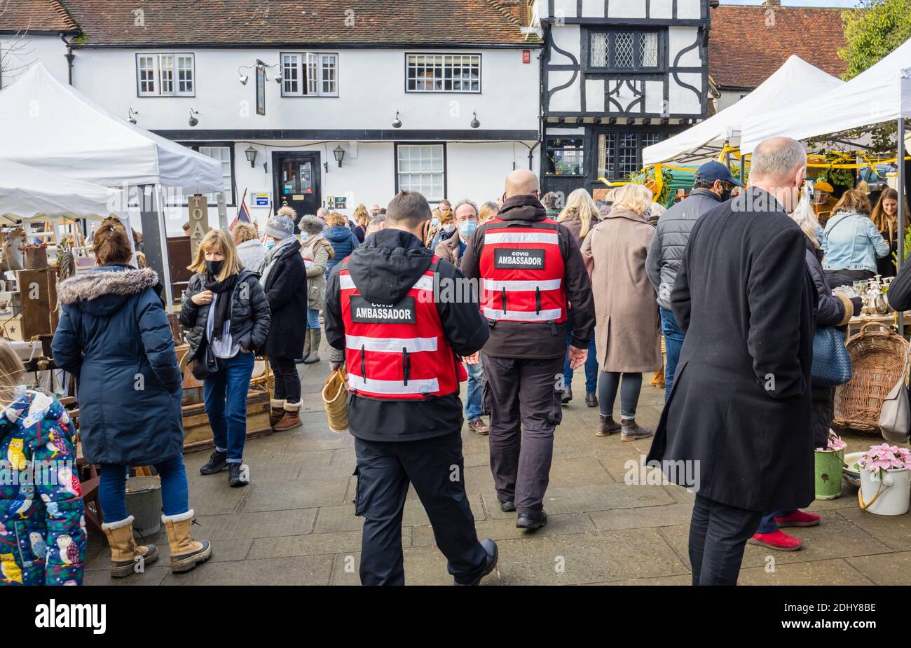 COVID ambassadors assist with social distancing and wearing face coverings at the Country Brocante Winter Fair, Market Square, Midhurst, West Sussex Stock Photo