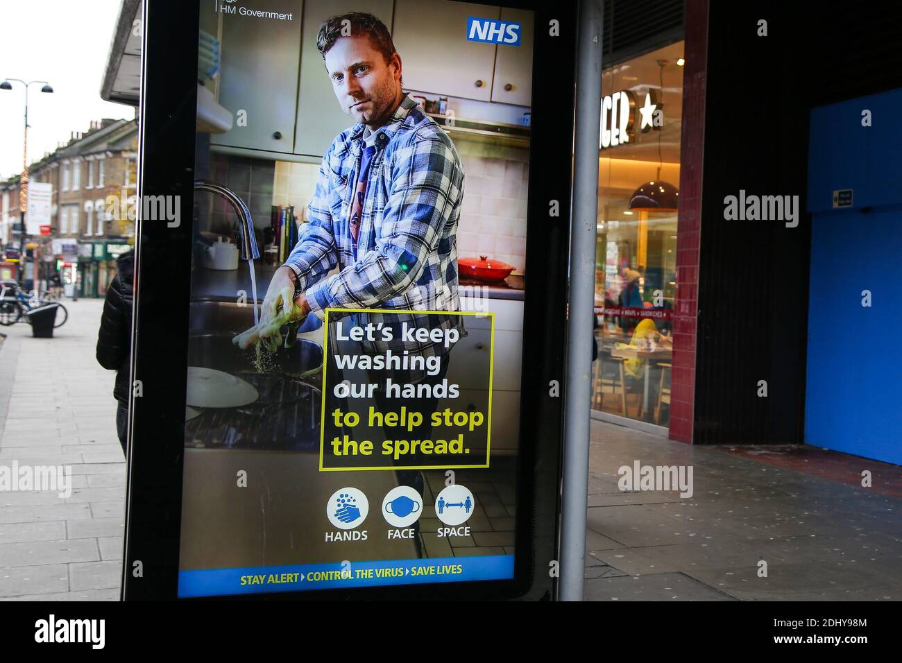 COIVD-19 public information campaign digital poster seen on display in London. Stock Photo