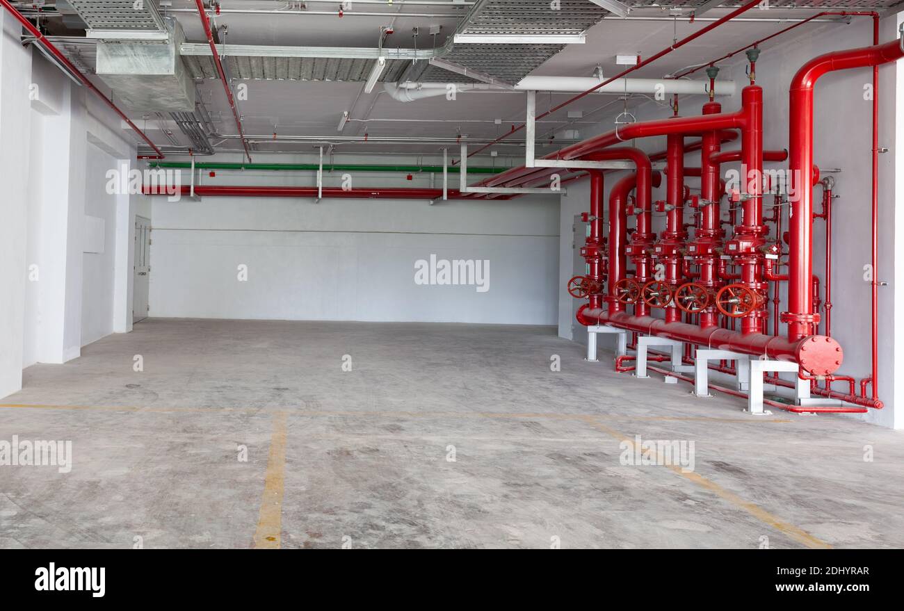 Parking garage interior, industrial building, hydrant with water hoses