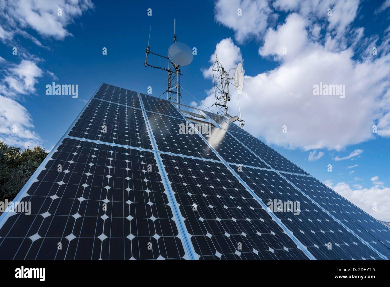 Solar communication equipment with partly cloudy sky in the Angeles National Forest near Los Angeles, California. Stock Photo