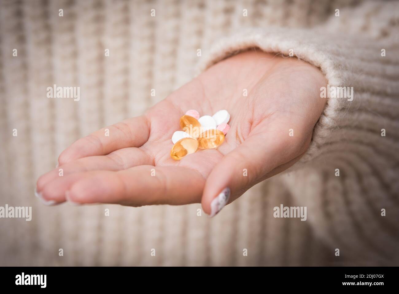 Woman hand with vitamins and medication. Taking vitamins and