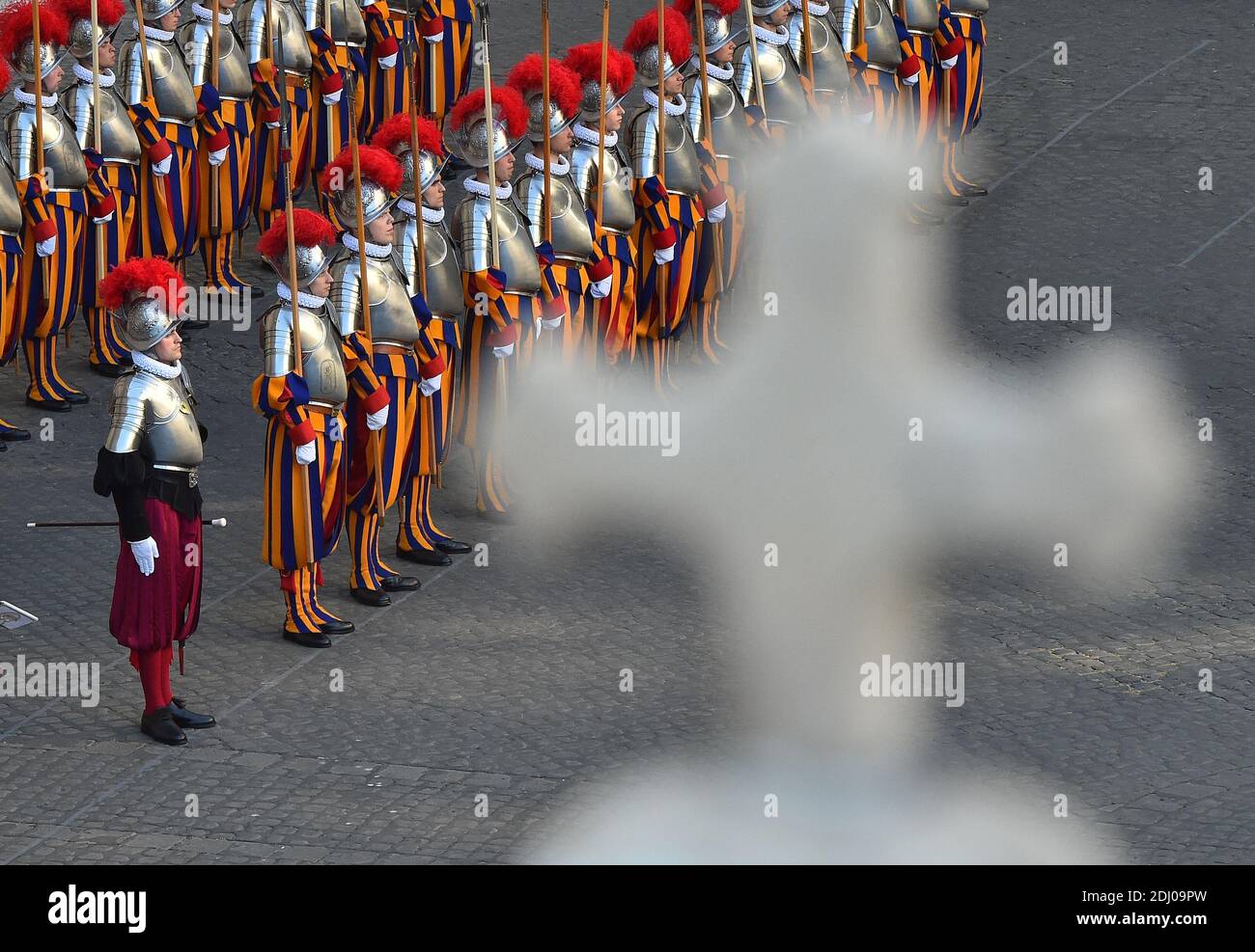 The Vatican's Swiss Guards swore in 23 new recruits on May 6, 2016 at the Vatican. The new recruits joined their ranks in an elaborate swearing-in ceremony . The ceremony is held each May 6 to commemorate the 147 Swiss Guards who died protecting Pope Clement VII during the 1527 Sack of Rome. Then each new recruit grasped the corps' flag and, raising three fingers in a symbol of the Holy Trinity, swore to uphold the Swiss Guard oath to protect pope Francis and his successors. The Swiss Guard, founded in 1506, consists of 100 volunteers who must be Swiss nationals, Catholic, single, at least 174 Stock Photo