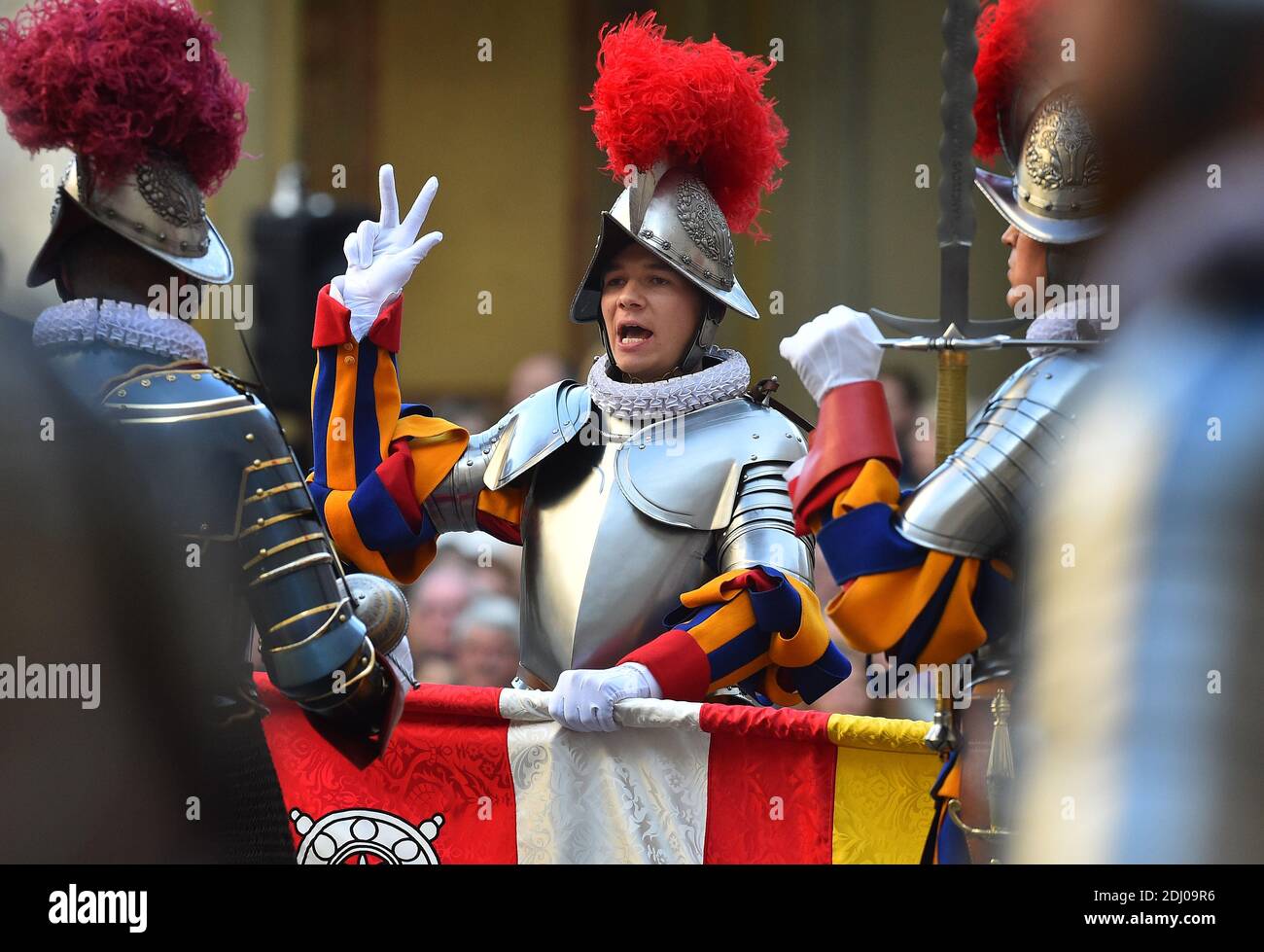 The Vatican's Swiss Guards swore in 23 new recruits on May 6, 2016 at the Vatican. The new recruits joined their ranks in an elaborate swearing-in ceremony . The ceremony is held each May 6 to commemorate the 147 Swiss Guards who died protecting Pope Clement VII during the 1527 Sack of Rome. Then each new recruit grasped the corps' flag and, raising three fingers in a symbol of the Holy Trinity, swore to uphold the Swiss Guard oath to protect pope Francis and his successors. The Swiss Guard, founded in 1506, consists of 100 volunteers who must be Swiss nationals, Catholic, single, at least 174 Stock Photo