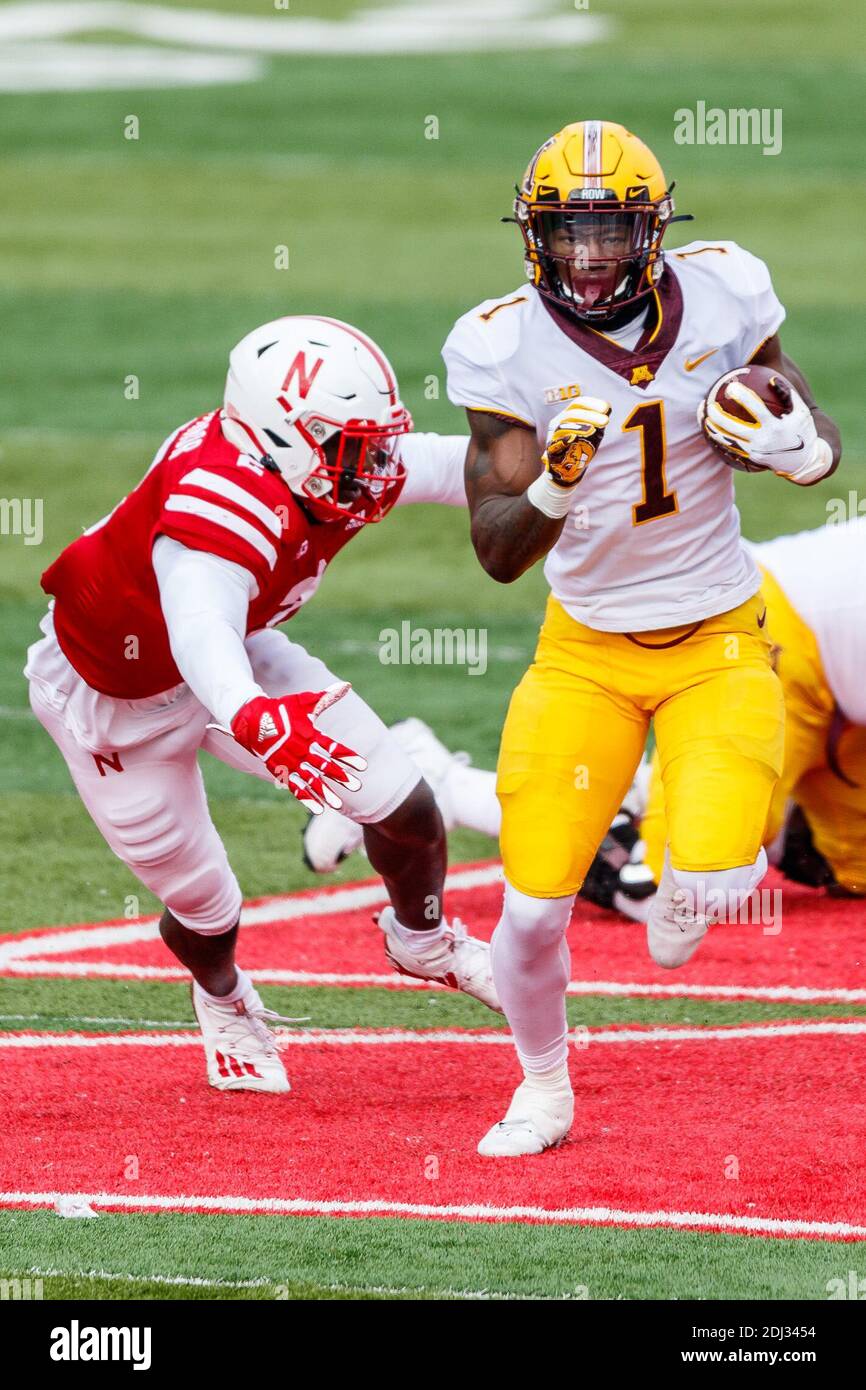 Lincoln, NE. U.S. 12th Dec, 2020. Minnesota Golden Gophers running back Cam Wiley #1 breaks through the line of scrimmage as Nebraska Cornhuskers linebacker Caleb Tannor #2 reaches to tackle in action during a NCAA Division 1 football game between Minnesota Golden Gophers and the Nebraska Cornhuskers at Memorial Stadium in Lincoln, NE. Minnesota won 24-17.Michael Spomer/Cal Sport Media/Alamy Live News Stock Photo