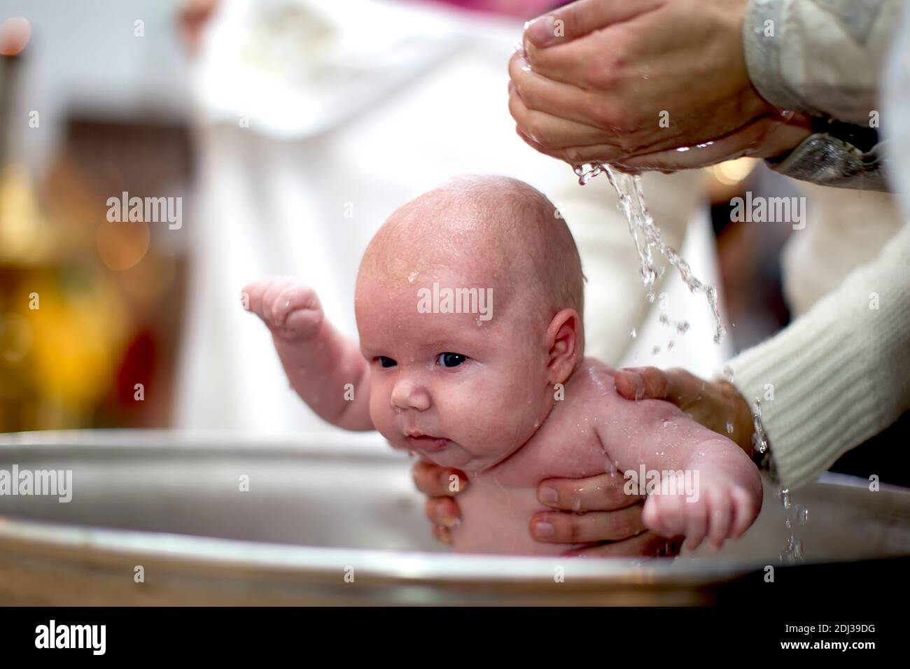 Orthodox baptism of a child.Baby in the baptismal font in the church