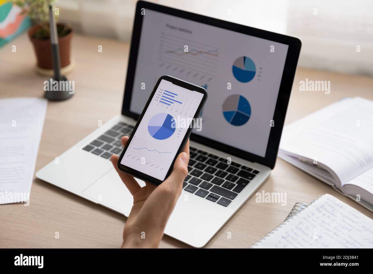Close up businesswoman holding working with project statistics on devices Stock Photo