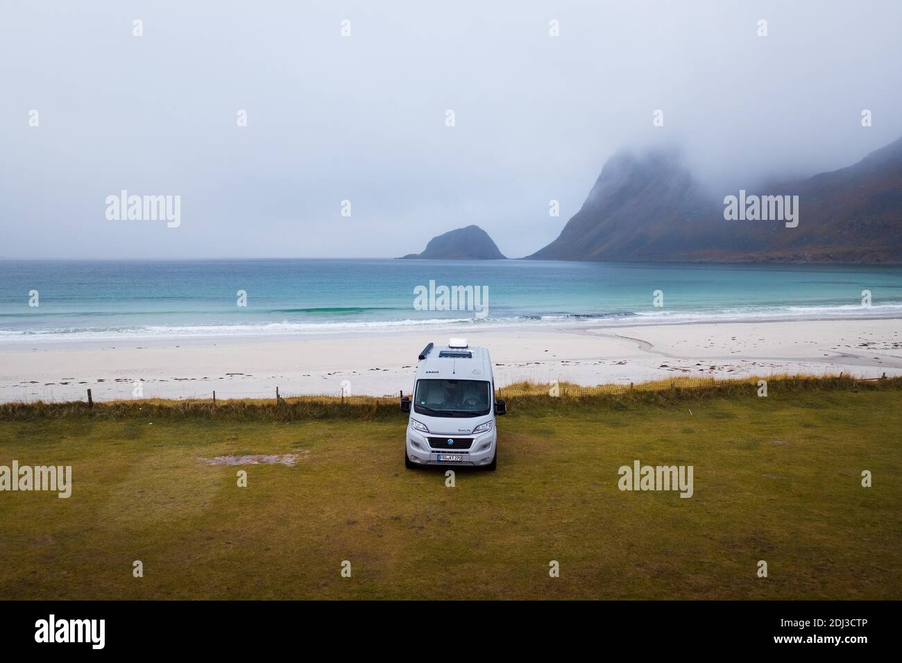 Drone shot, camping van on grass in front of a fine sandy beach, Haukland beach, Lofoten, Norway Stock Photo