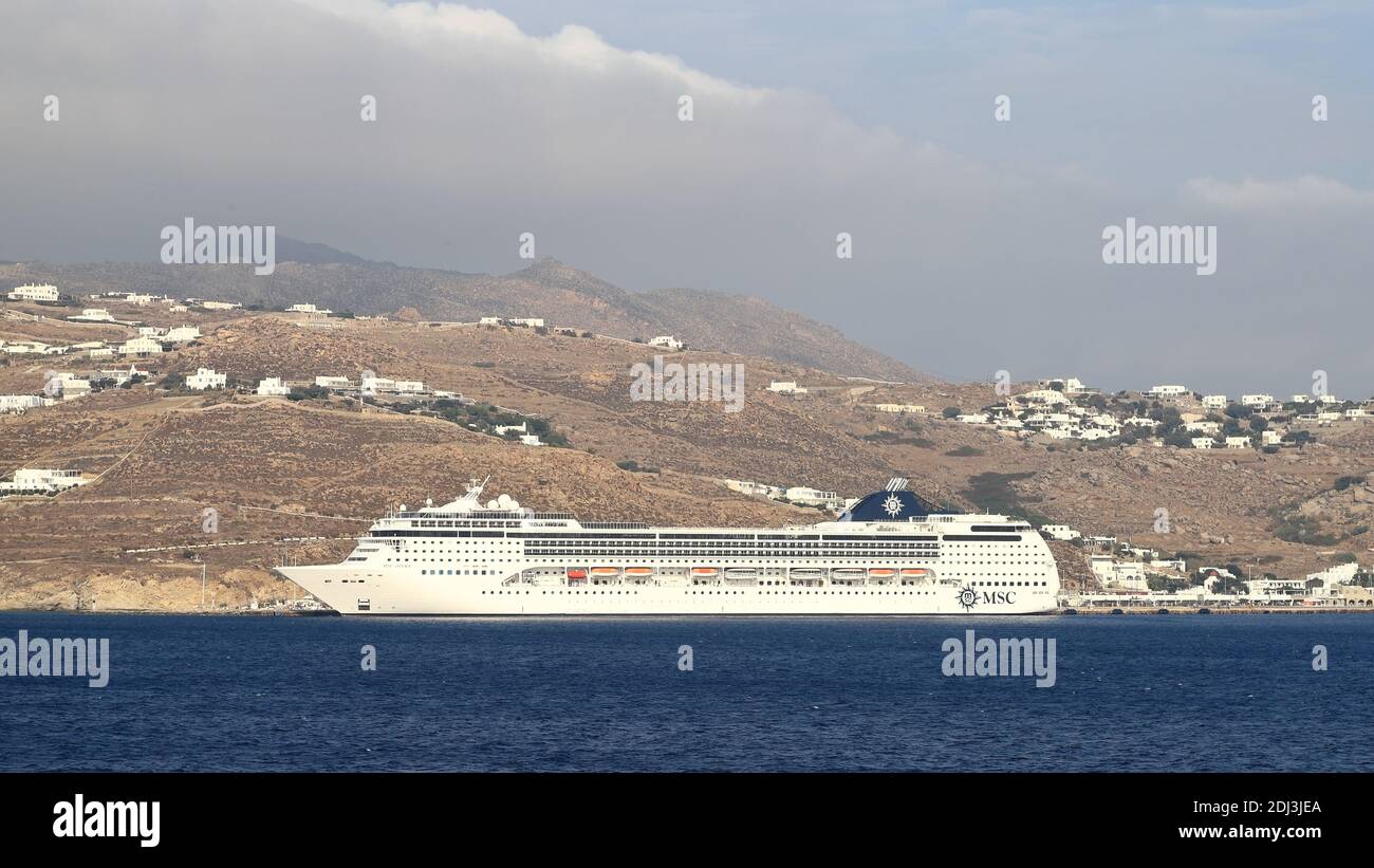 MSC cruise ship, Opera, moored on the coast of the Greek island of Mykonos.  The cruise ship entered service in 2004. Stock Photo