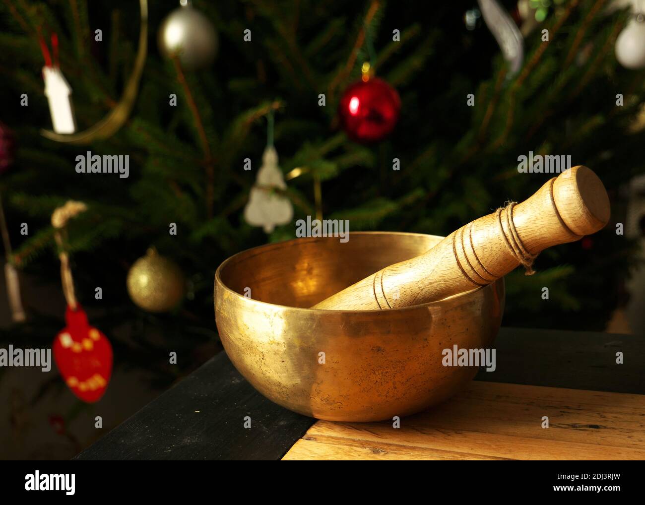 Singing bowl with Christmas decorations in the background Stock Photo