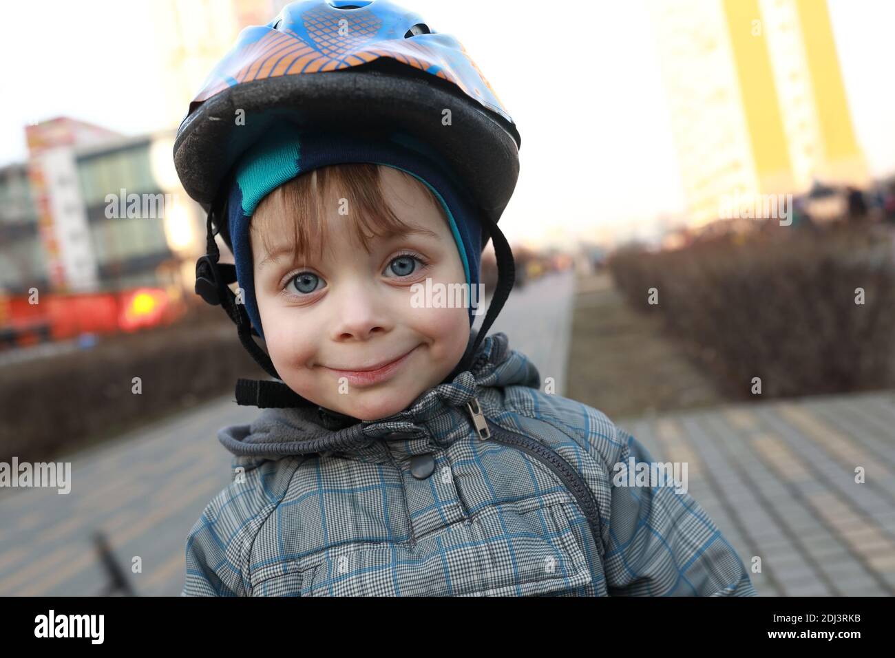Portrait of smiling child with crash helmet in spring Stock Photo Alamy