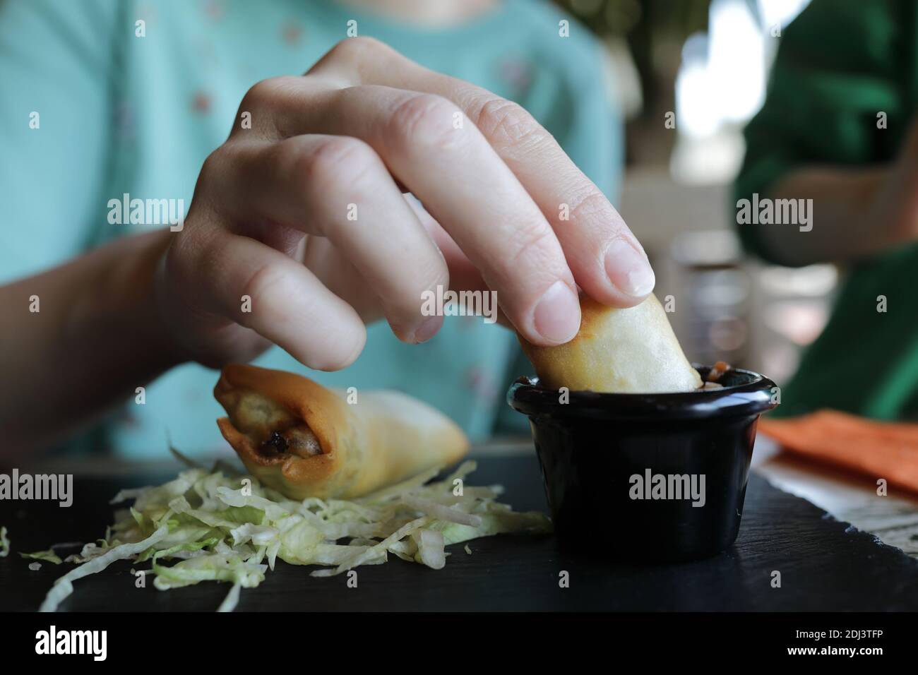 Woman eating burritos in a mexican restaurant Stock Photo