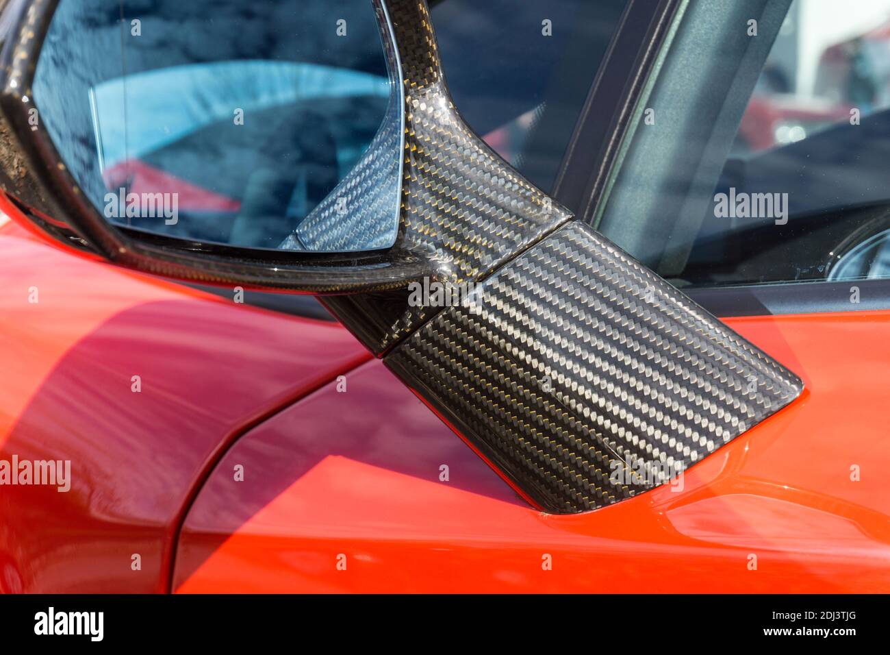 Close up detail of the carbon fibre side door mirror on a Rosso Mars red Lamborghini Gallardo LP 570-4 Super Trofeo Stradale Stock Photo