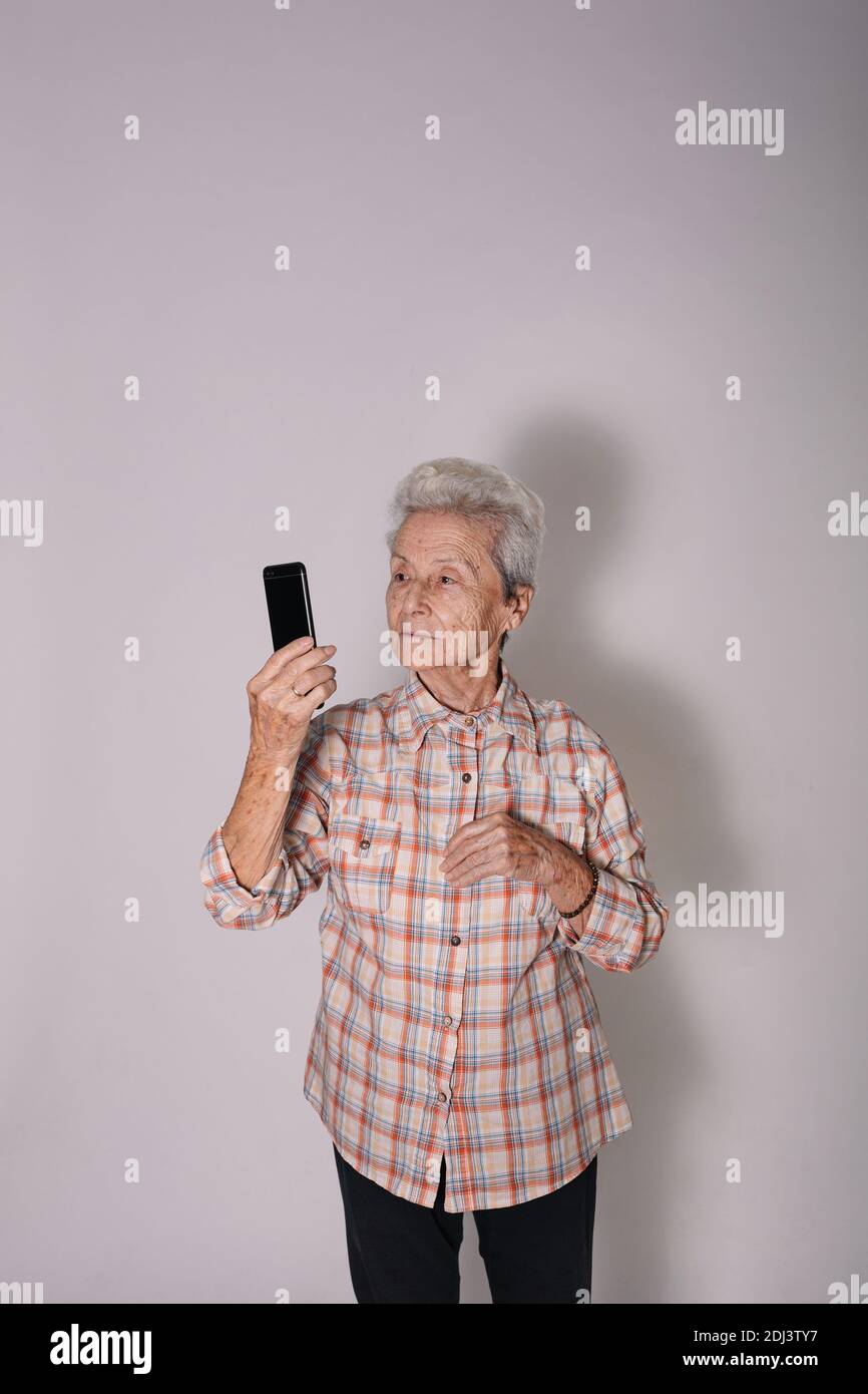 Grandmother looking at a smartphone. Stock Photo