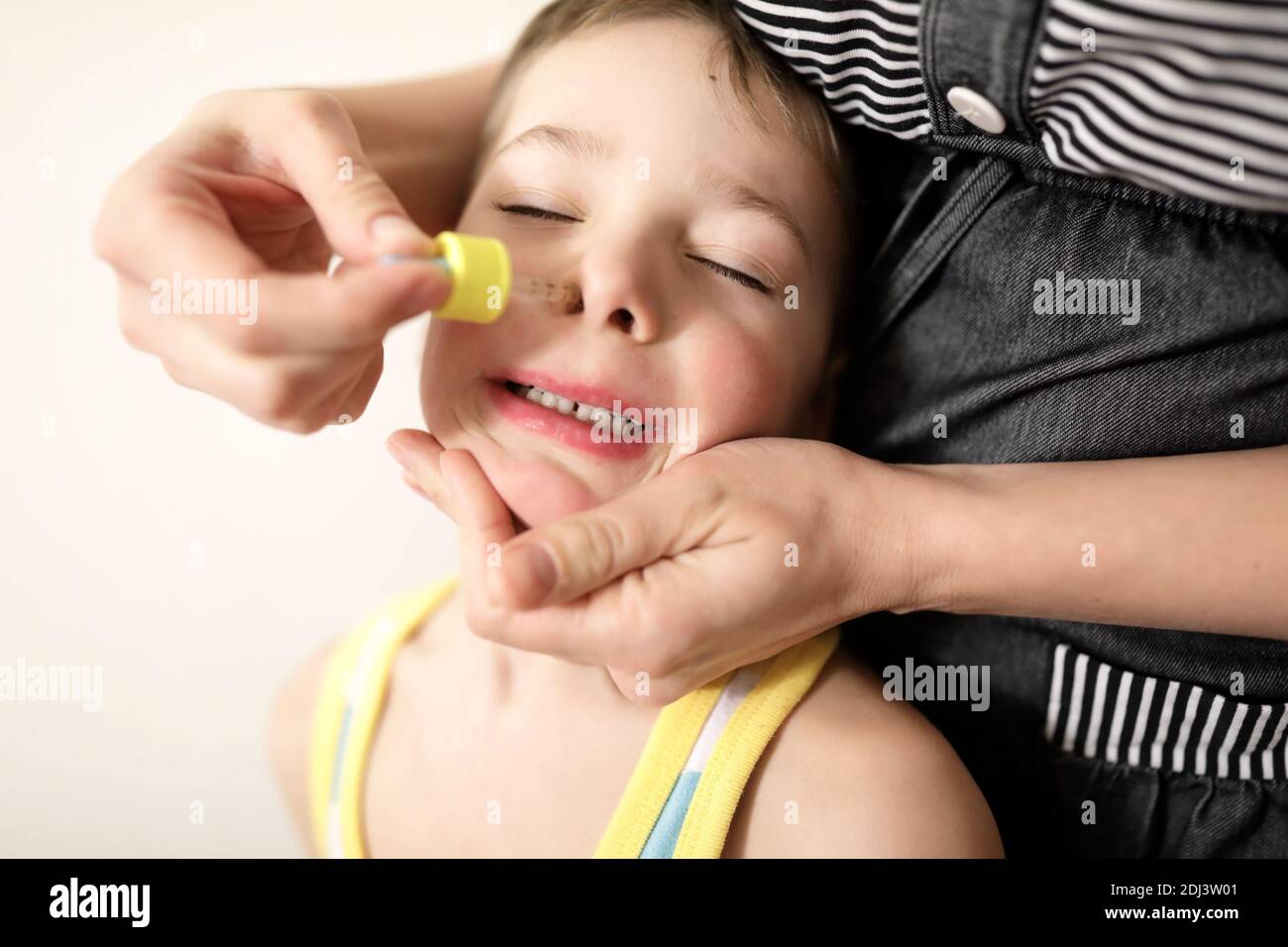 Treatment of a kid cold at home Stock Photo