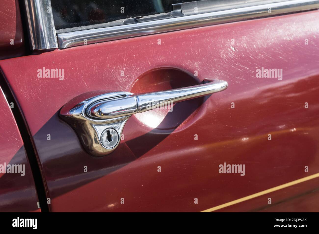 Close up detail of the chrome door handle on a maroon Vanden Plas Princess 1100 four-door British saloon car Stock Photo