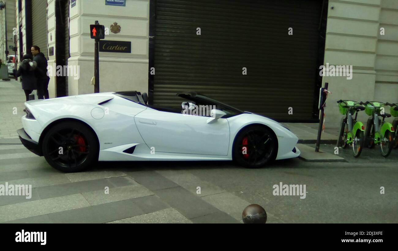 Paris, France - January 2018: A white Lamborghini aventador parked along the elisee champs in front of Cartier's window Stock Photo