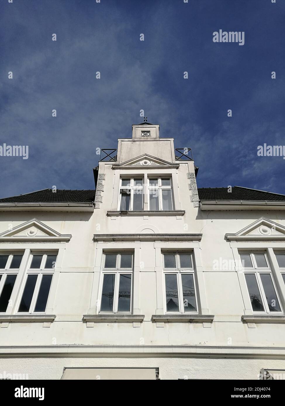 A vertical low angle shot of a building captured during the daytime ...