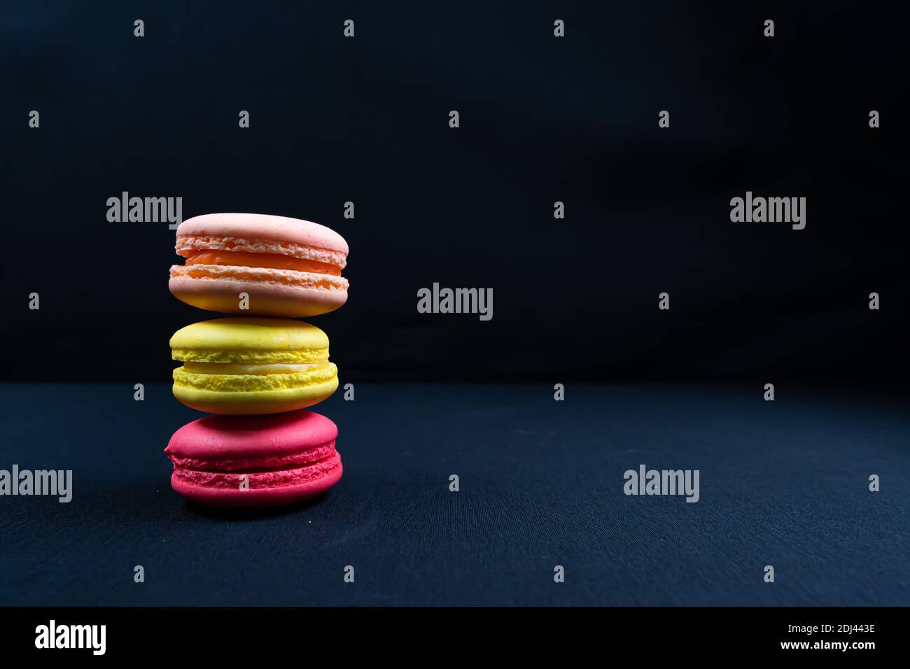 Colourful stack of macaroons isolated on plain black background, Copyspace  Stock Photo - Alamy